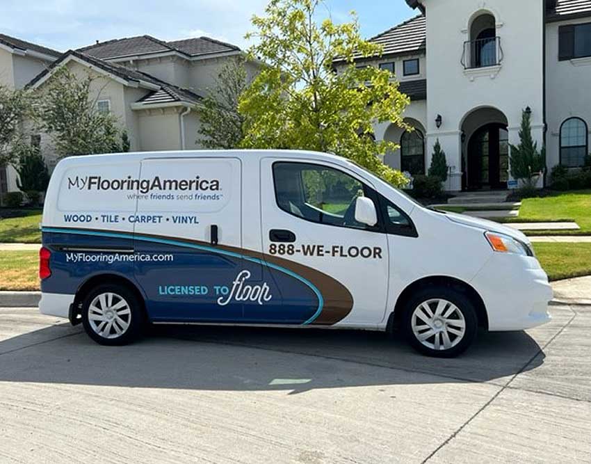 My. Flooring America van parked in front of brick house on sunny day