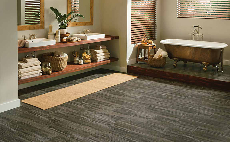 Tropical oasis styled bathroom with slate colored wood floors